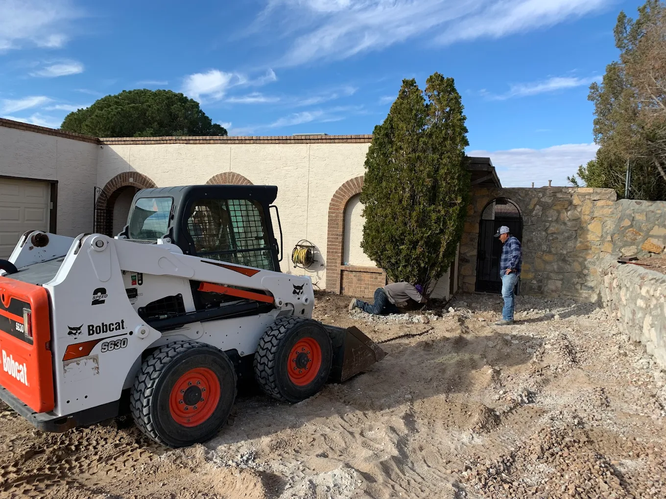Santa Cruz Trucking Bobcat preparing an El Paso property